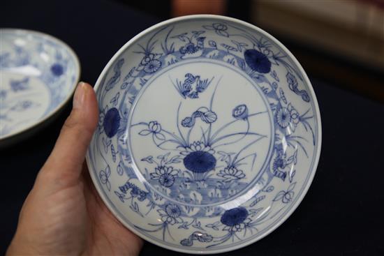 A near pair of Chinese blue and white mandarin duck and pond saucer dishes, Yongzheng mark and of the period (1723-35), diameter 15.5